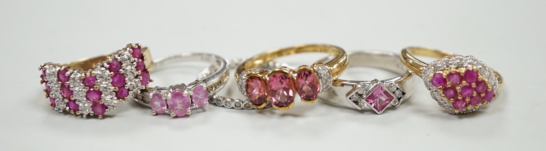 Five assorted modern 9ct gold and gem set dress rings, gross weight 16.7 grams and one other white metal and gem set eternity ring.